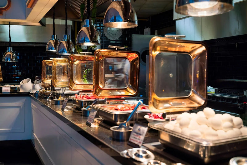 Commercial kitchen with gold-colored appliances and food preparation area