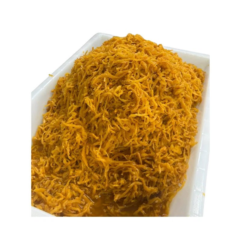 Sweet preserved radish shredded on a white background