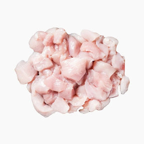 Chopped chicken for curry on a white background