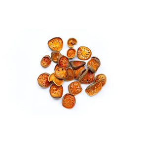 Dried bael fruit slices, traditional herbal ingredient, 100g pack isolated on white background