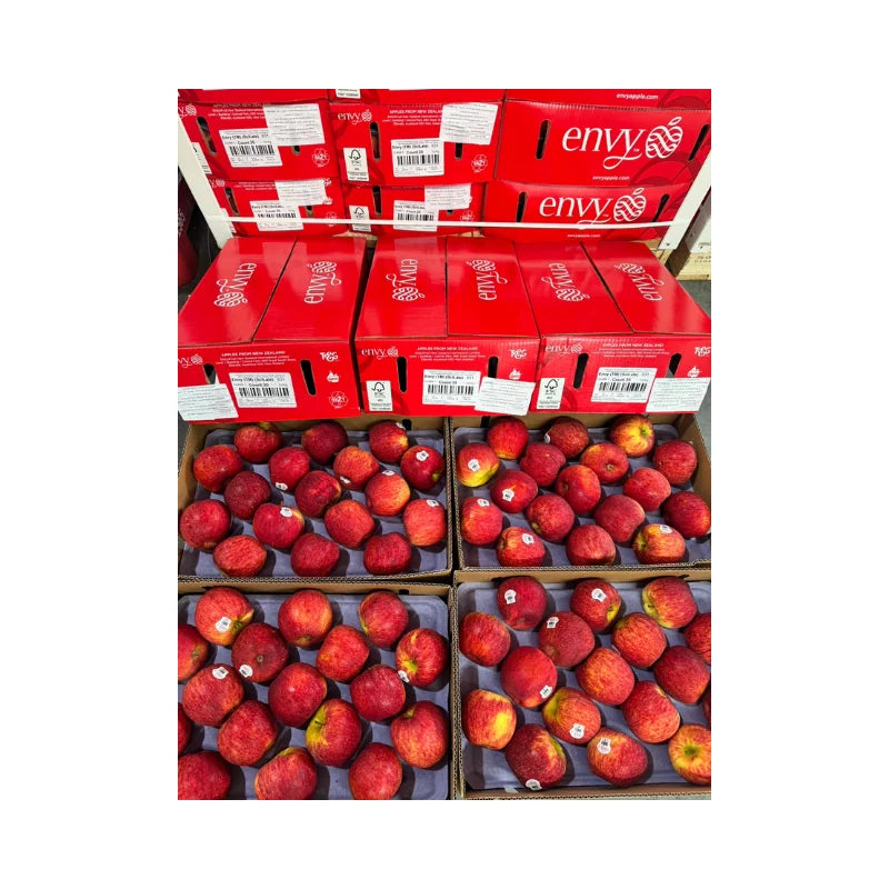 Red 'envy' apple boxes with apples inside on a white background