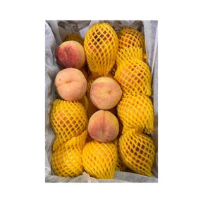 Fresh fuzzy peaches, ripe peaches with soft skin packed per box isolated on white background