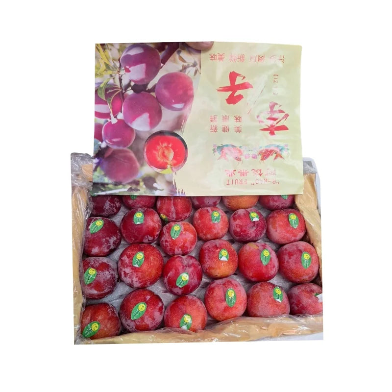 Box of red fruits with a packaging bag featuring images of the fruits and text.