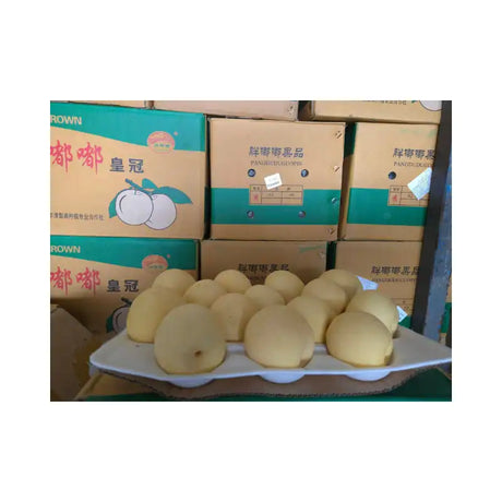 Pears on a tray with boxes in the background