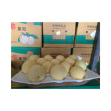 Platter of white fruits with boxes in the background