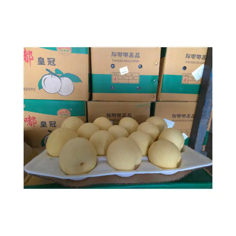 Platter of white fruits with boxes in the background