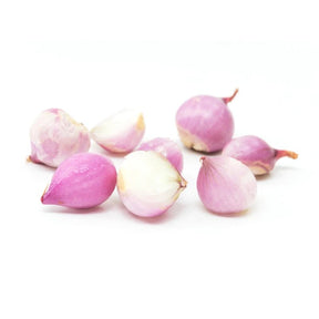 Peeled shallots on a white background